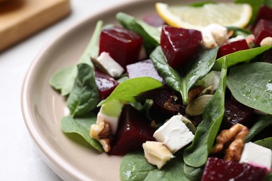 Photo of Delicious beet salad served on table, closeup