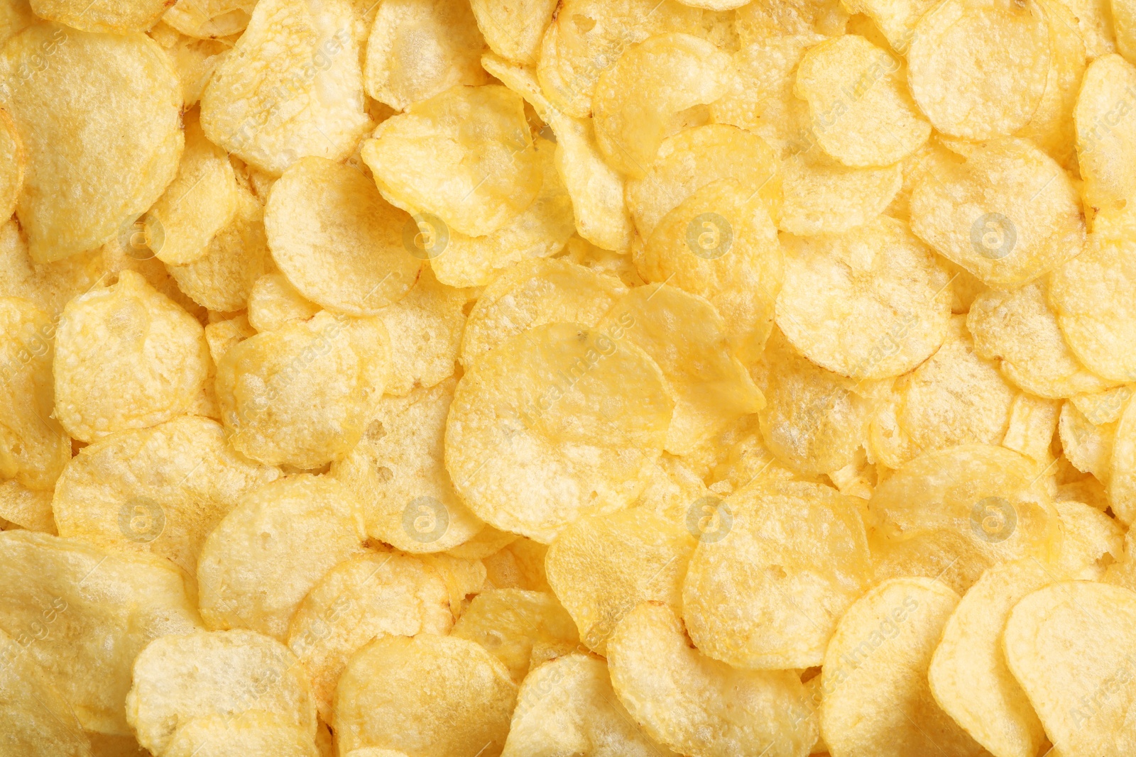 Photo of Crispy potato chips as background, top view