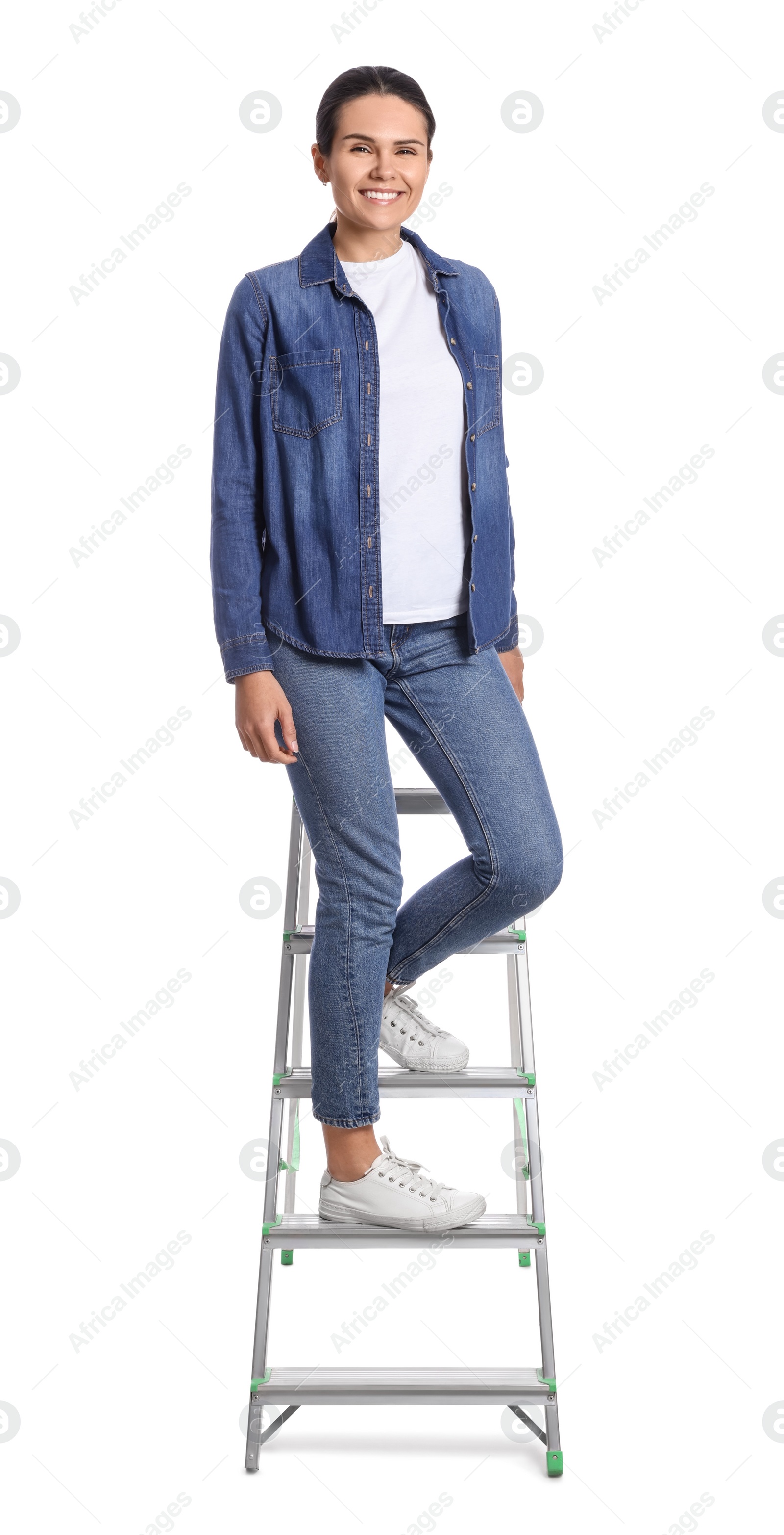 Photo of Young woman sitting on metal ladder against white background