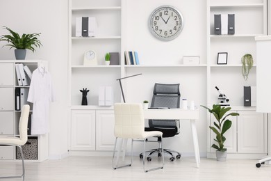 Photo of Modern medical office interior with doctor's workplace