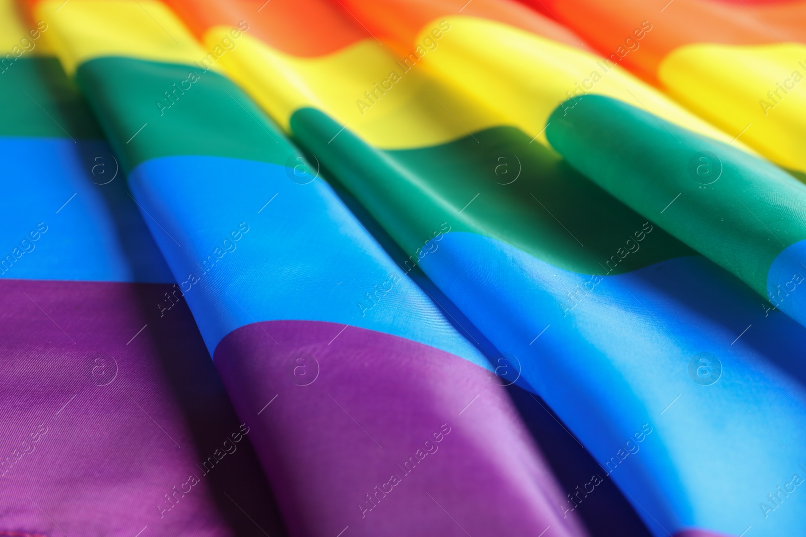 Photo of Bright rainbow gay flag as background. LGBT community