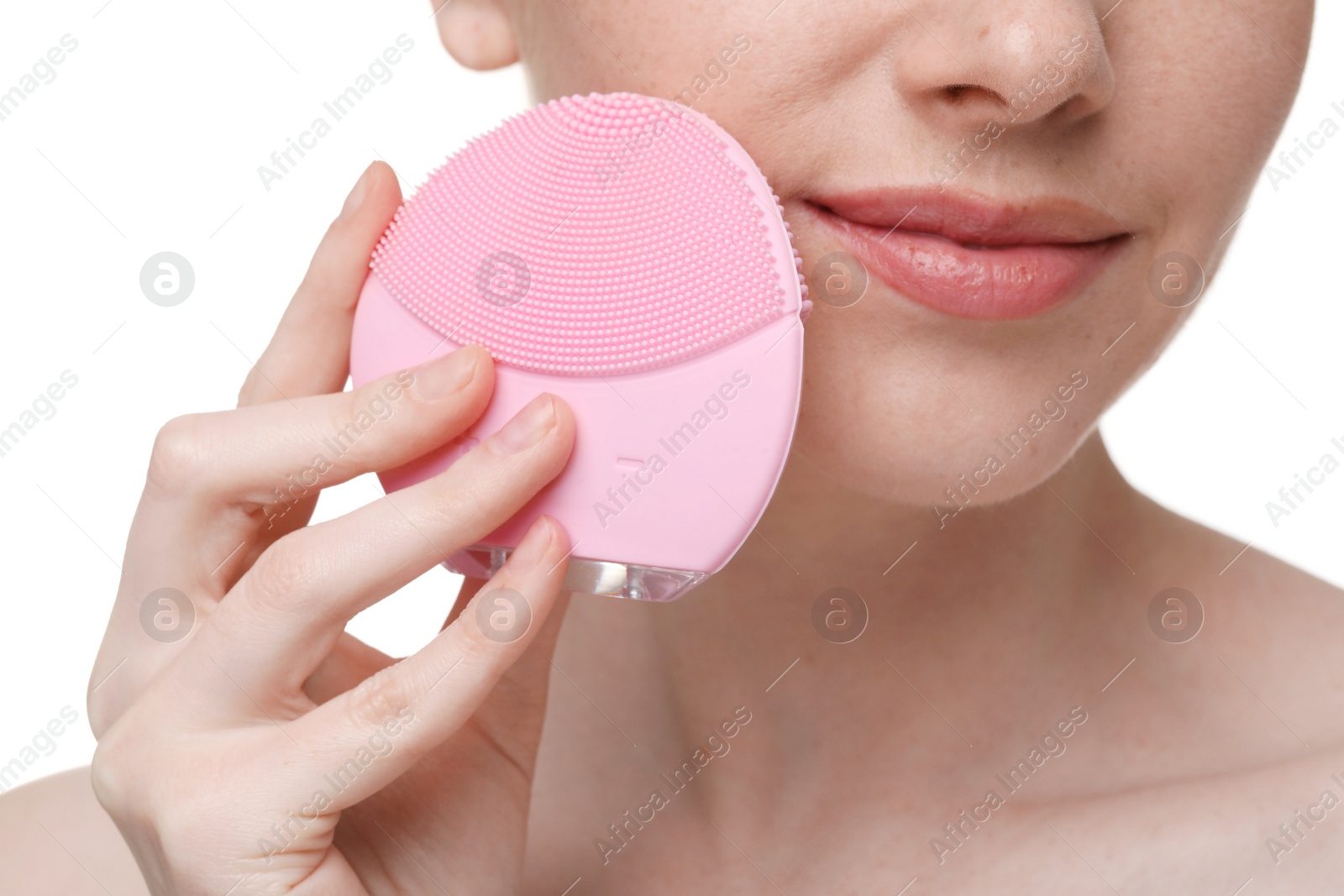 Photo of Washing face. Young woman with cleansing brush on white background, closeup
