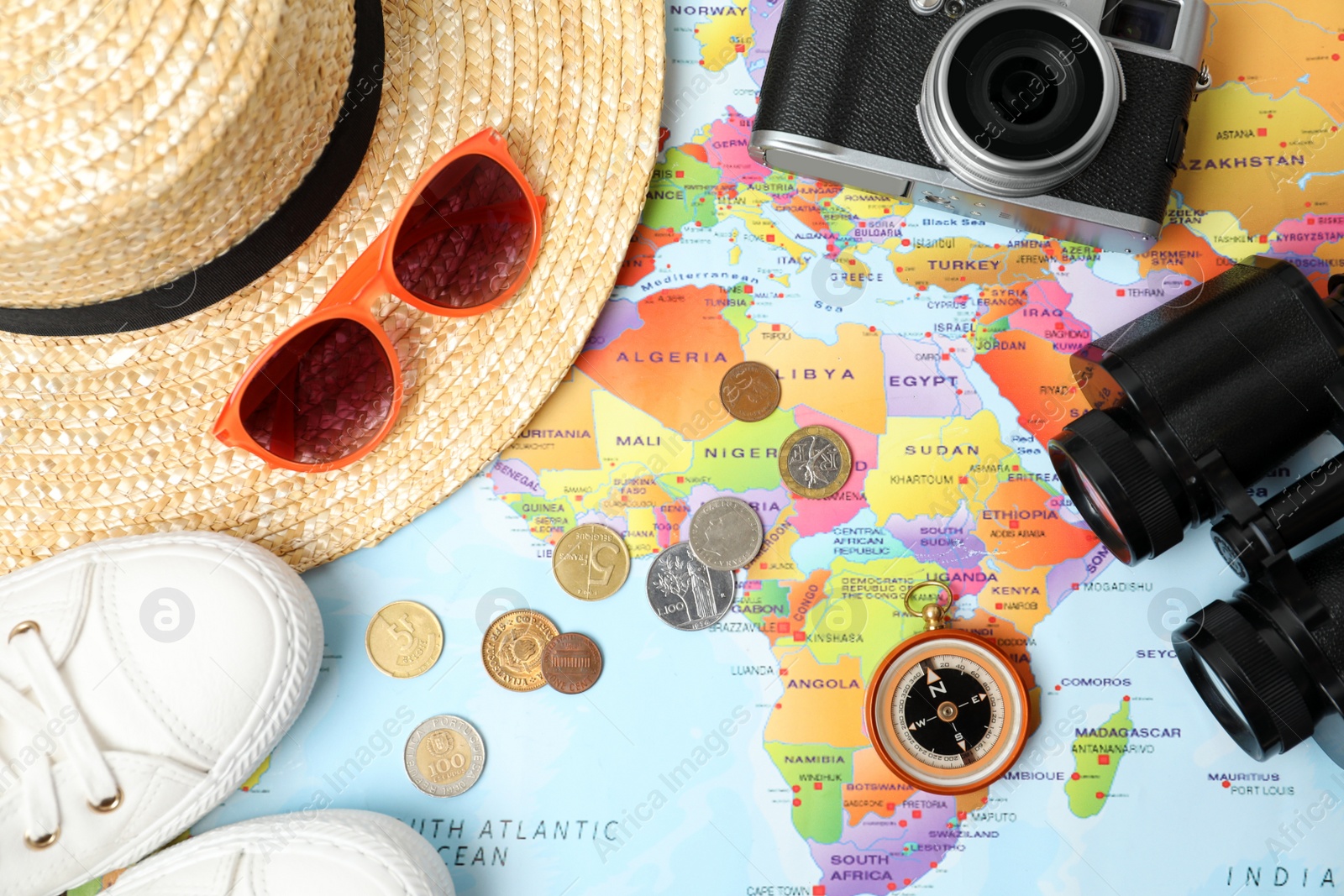 Photo of Flat lay composition with different travel accessories on world map. Planning summer vacation trip