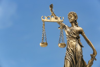 Photo of Symbol of fair treatment under law. Figure of Lady Justice against sky, closeup with space for text