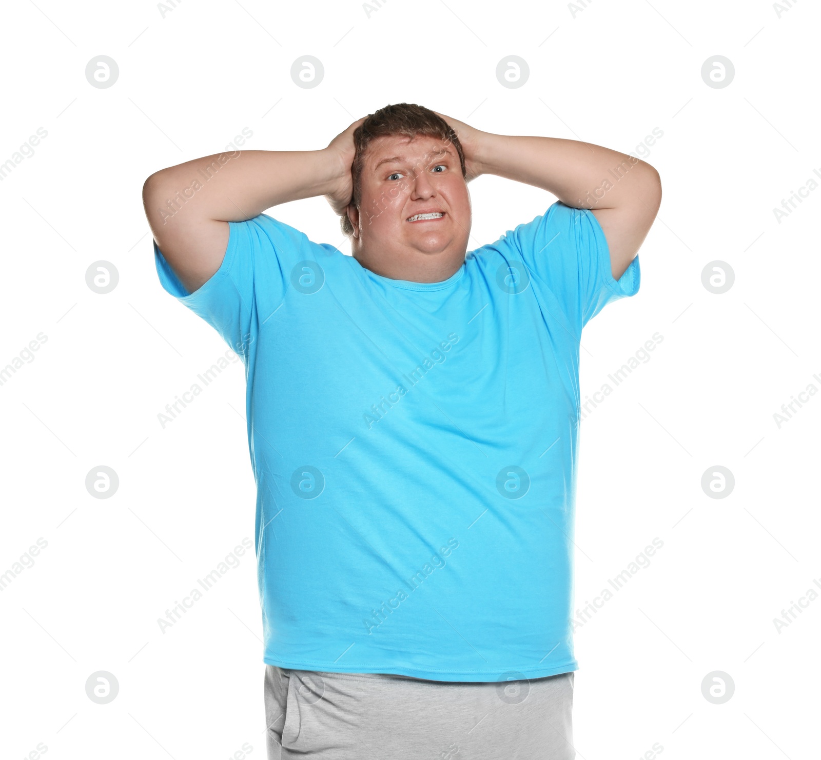 Photo of Emotional overweight man posing on white background