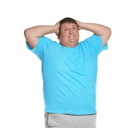 Emotional overweight man posing on white background