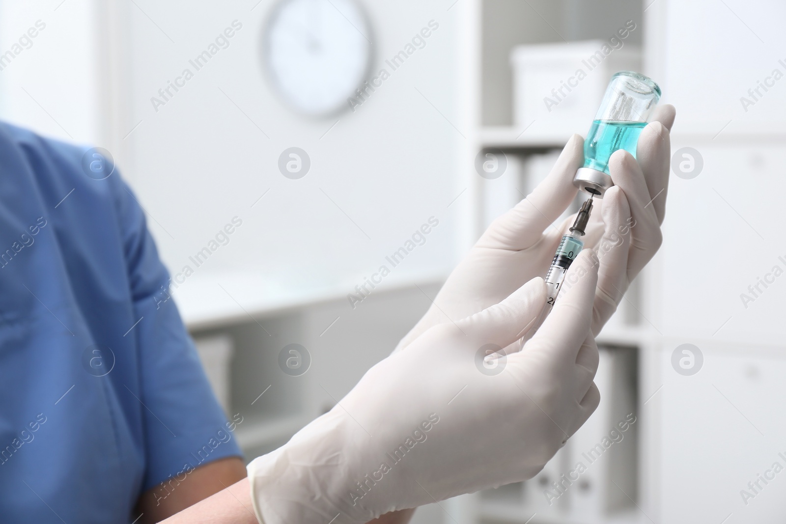 Photo of Doctor filling syringe with medication from vial in hospital, closeup