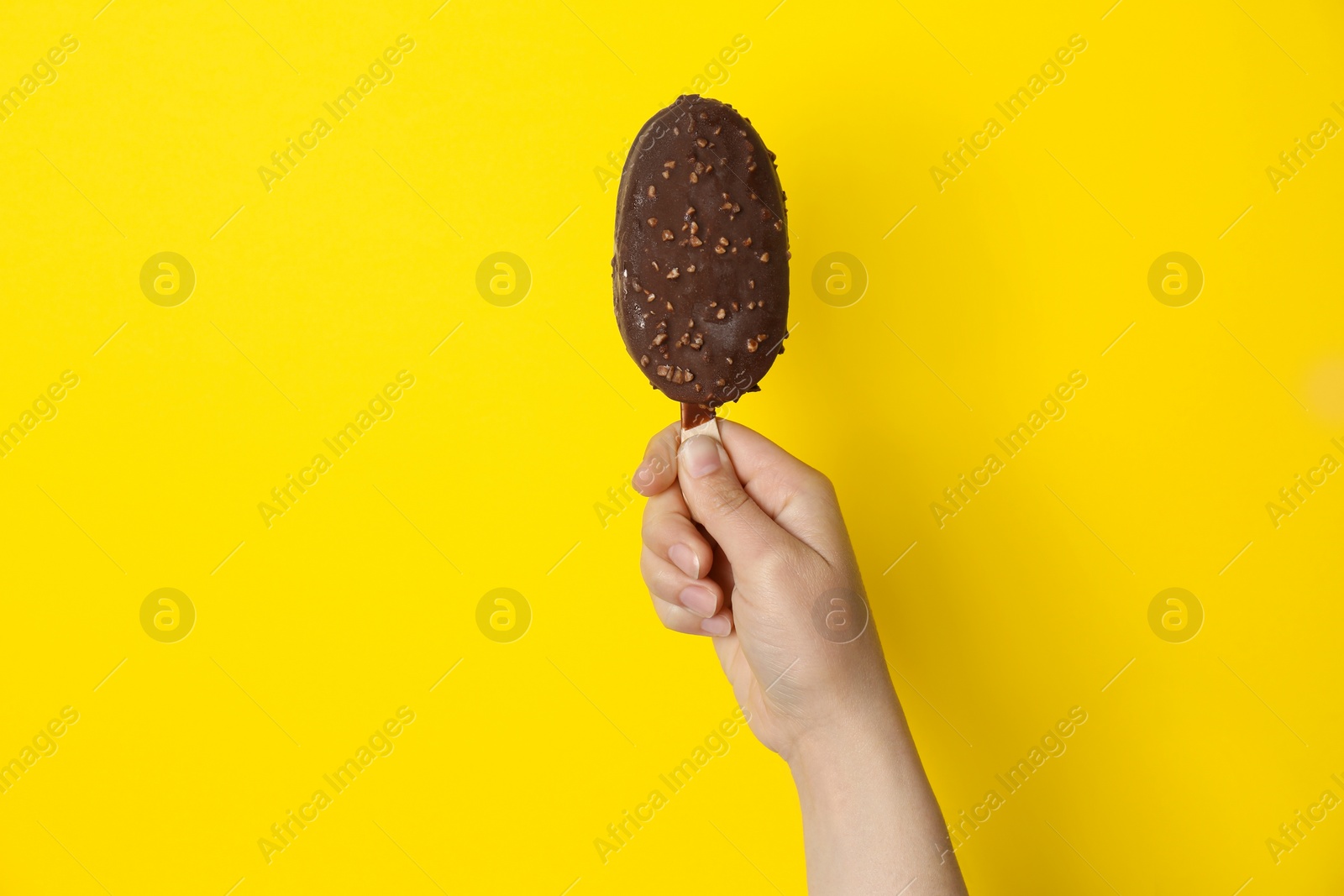 Photo of Woman holding delicious ice cream with chocolate against color background