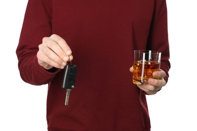 Photo of Man with glass of alcoholic drink and car keys on white background, closeup. Don't drink and drive concept