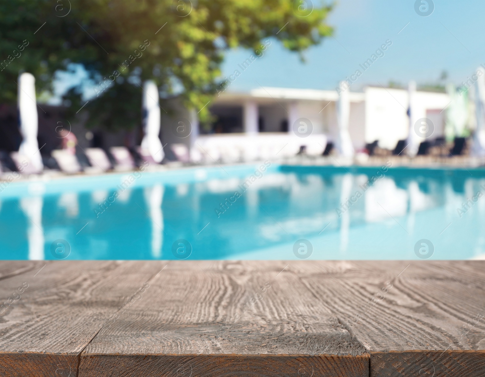 Image of Wooden deck near swimming pool outdoors on sunny day. Space for text