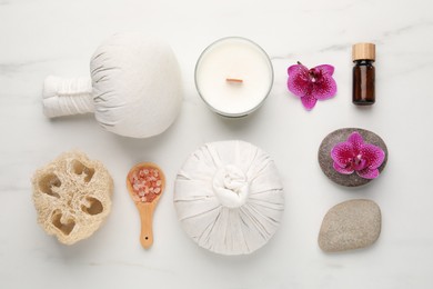 Flat lay composition with different spa products on white marble table