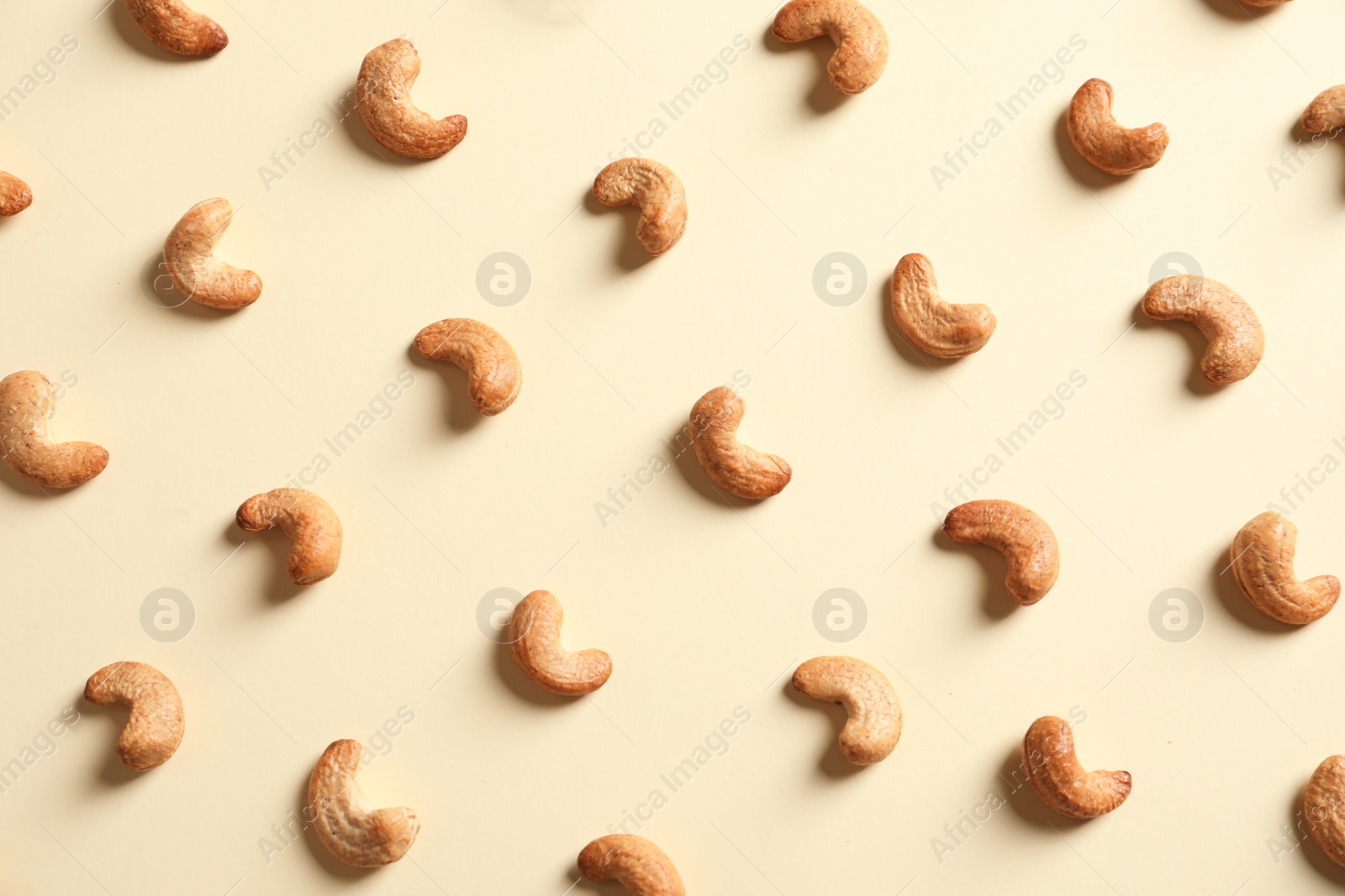 Photo of Tasty cashew nuts on light background, flat lay