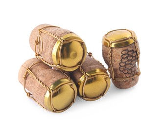 Photo of Corks of sparkling wine and muselet caps on white background