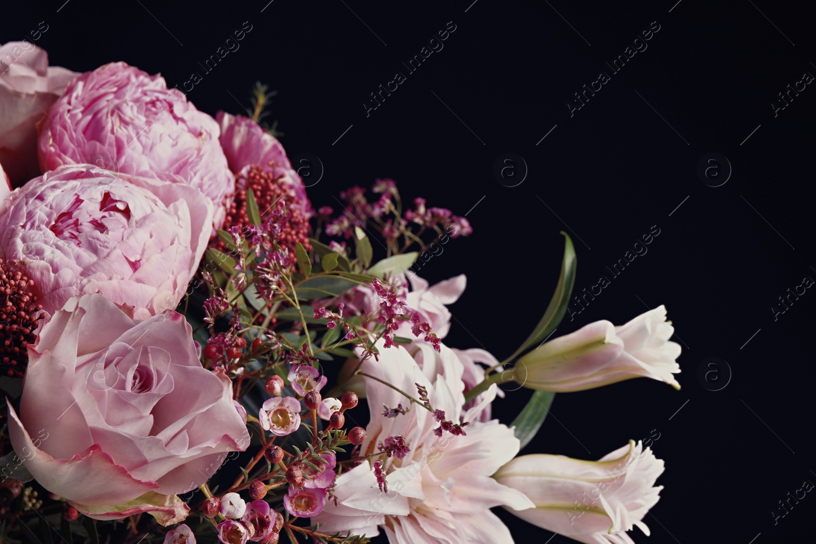 Photo of Beautiful bouquet of different flowers on black background. Floral card design with dark vintage effect