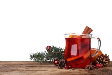 Tasty aromatic mulled wine on wooden table against white background