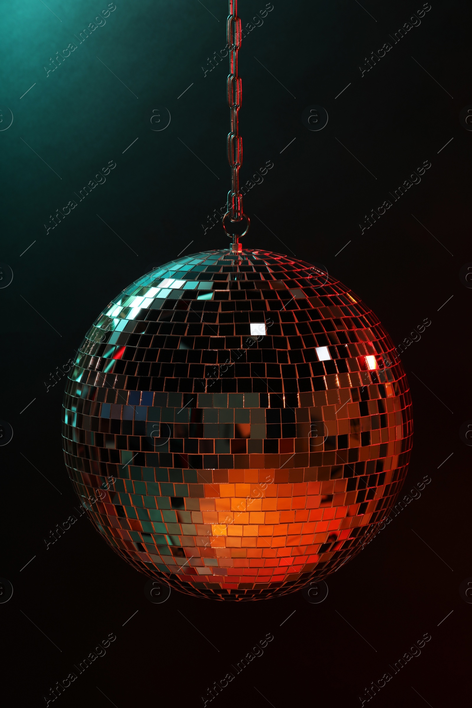 Photo of Shiny bright disco ball on dark background