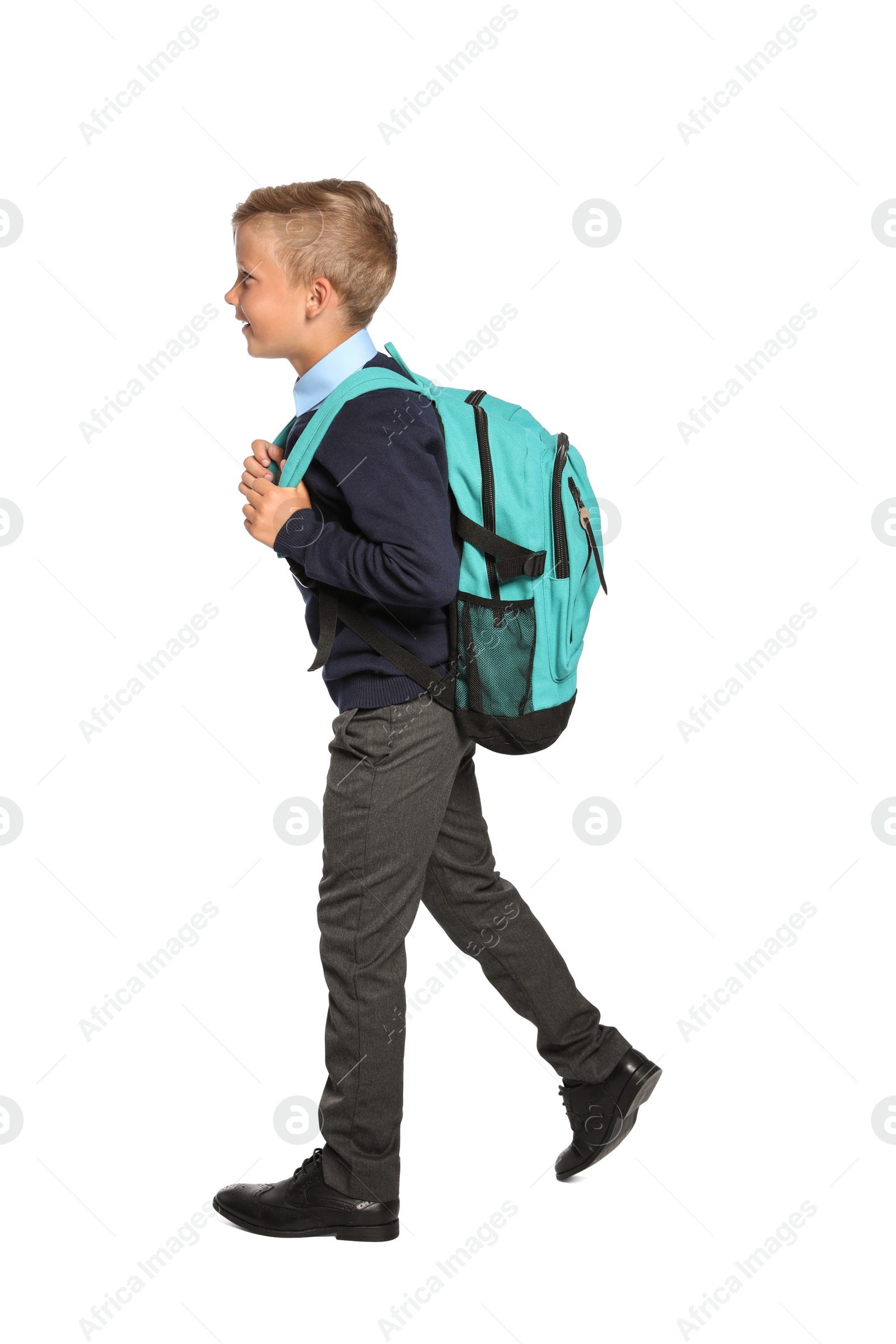 Photo of Little boy in stylish school uniform on white background