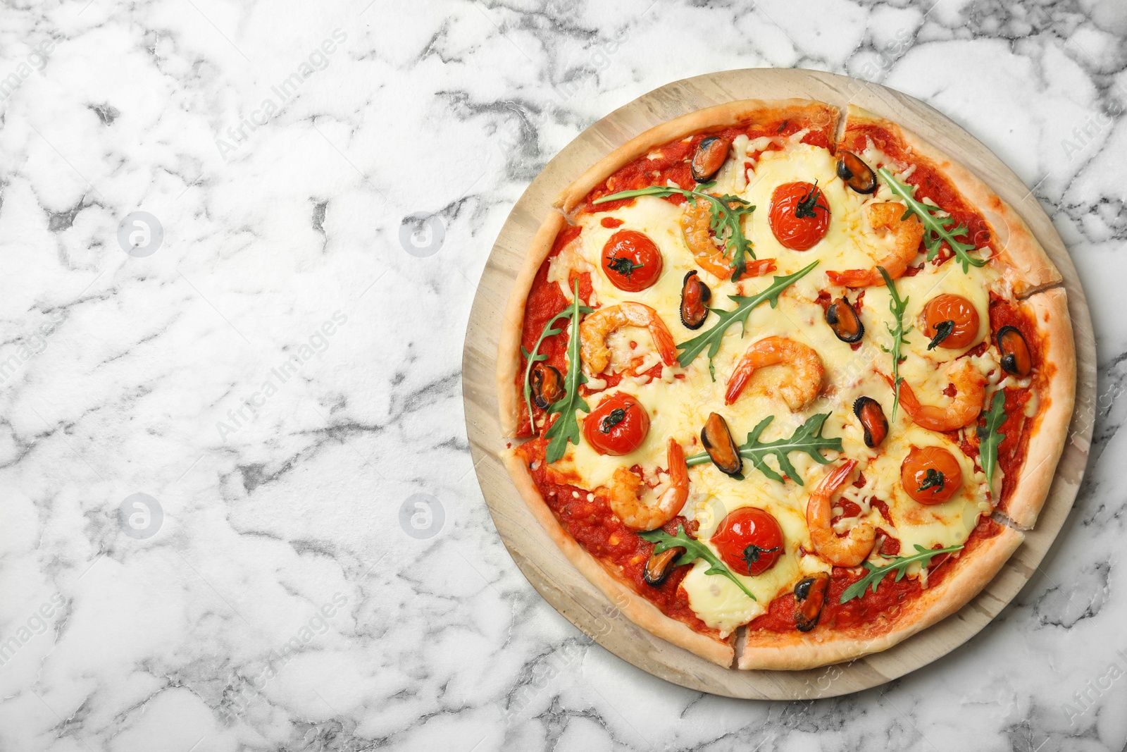 Photo of Delicious seafood pizza on white marble table. Space for text