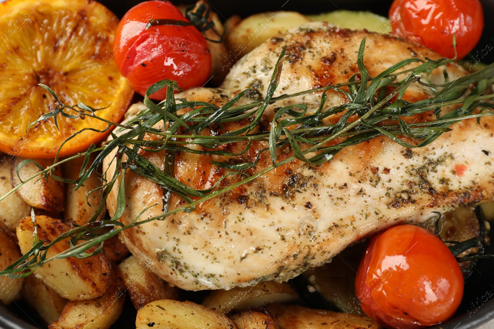 Photo of Tasty chicken and vegetables with tarragon, closeup