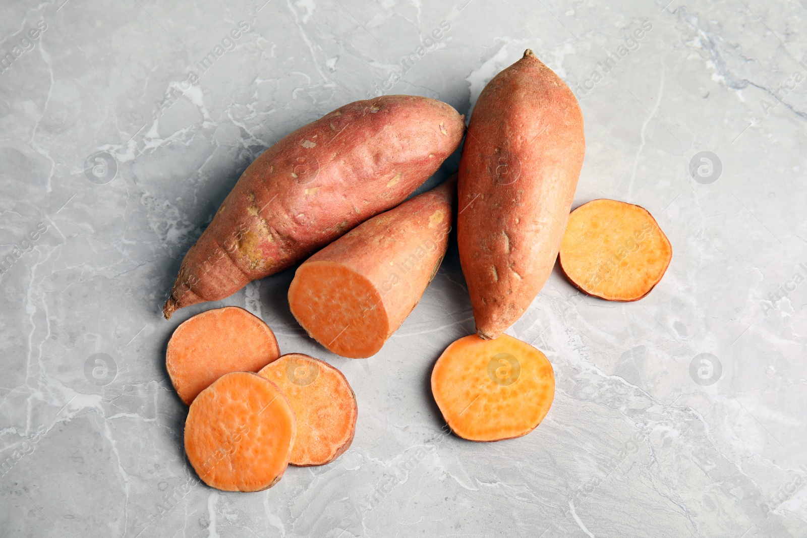 Photo of Flat lay composition with sweet potatoes on grey background