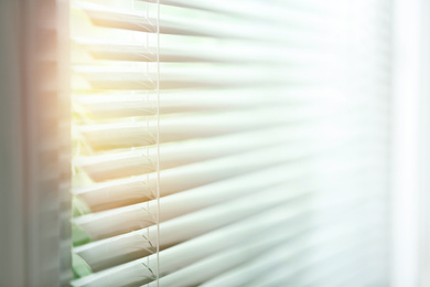 Image of Window with blinds on sunny day, closeup