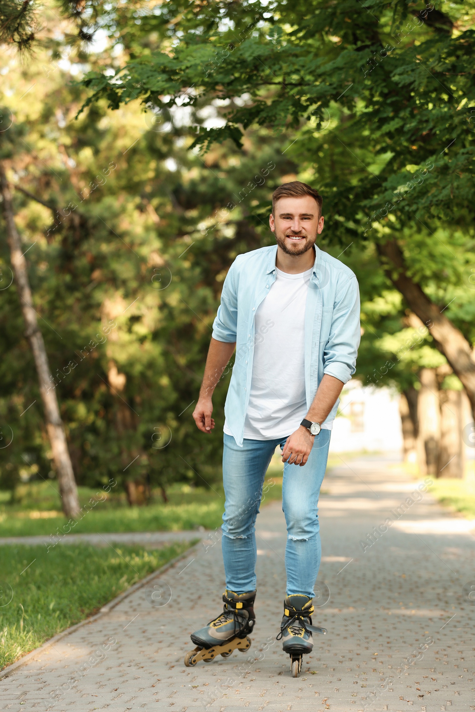 Photo of Young man roller skating in summer park