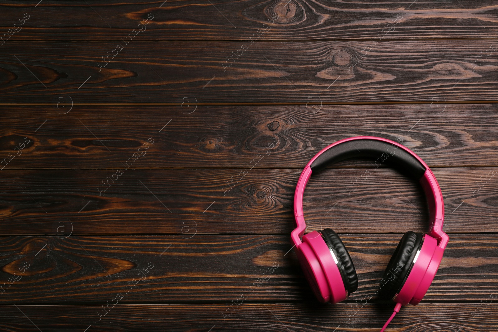 Photo of Stylish headphones on wooden background, top view. Space for text