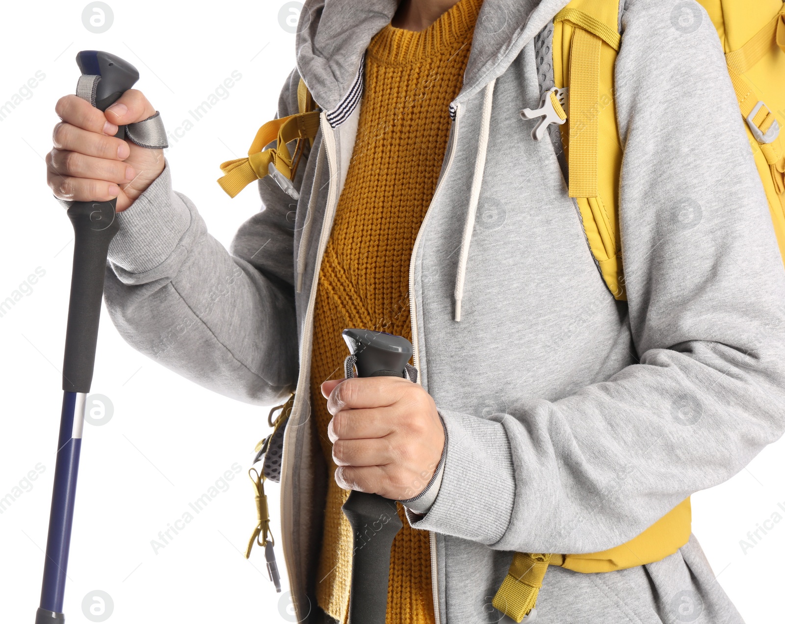 Photo of Female hiker with backpack and trekking poles on white background, closeup