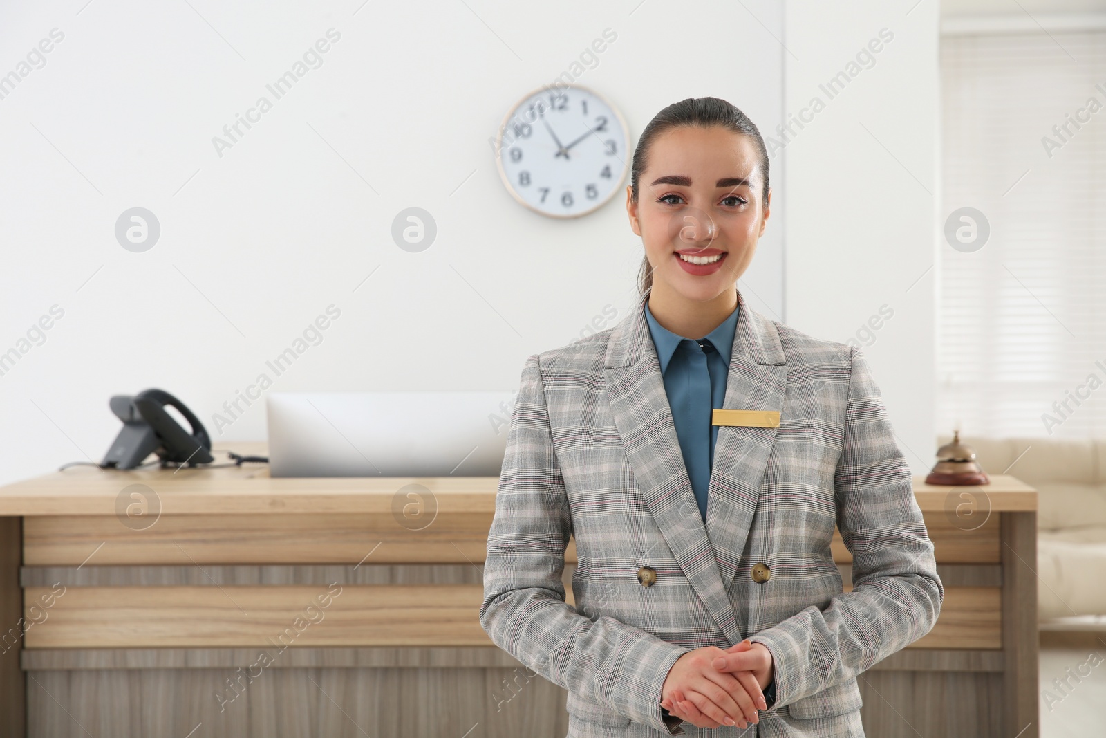 Photo of Portrait of beautiful receptionist near counter in hotel