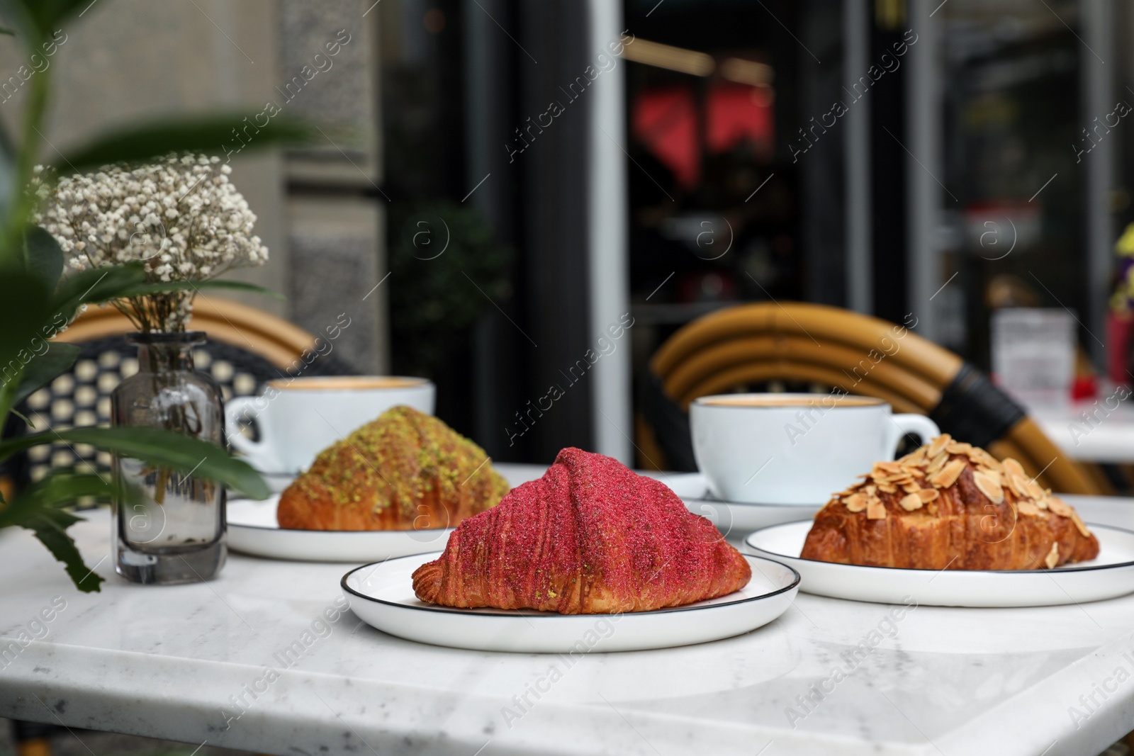 Photo of Delicious croissants on white marble table in cafe