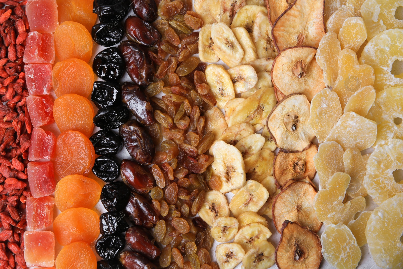 Photo of Different tasty dried fruits as background, top view