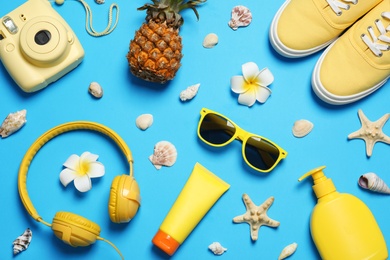 Flat lay composition with beach accessories on color background