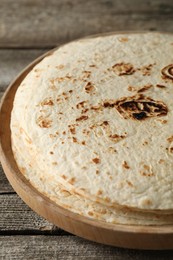 Stack of tasty homemade tortillas on wooden table