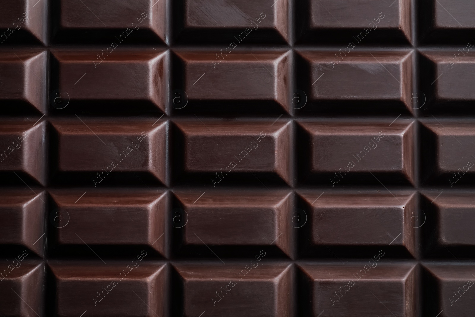 Photo of Delicious dark chocolate bar as background, closeup