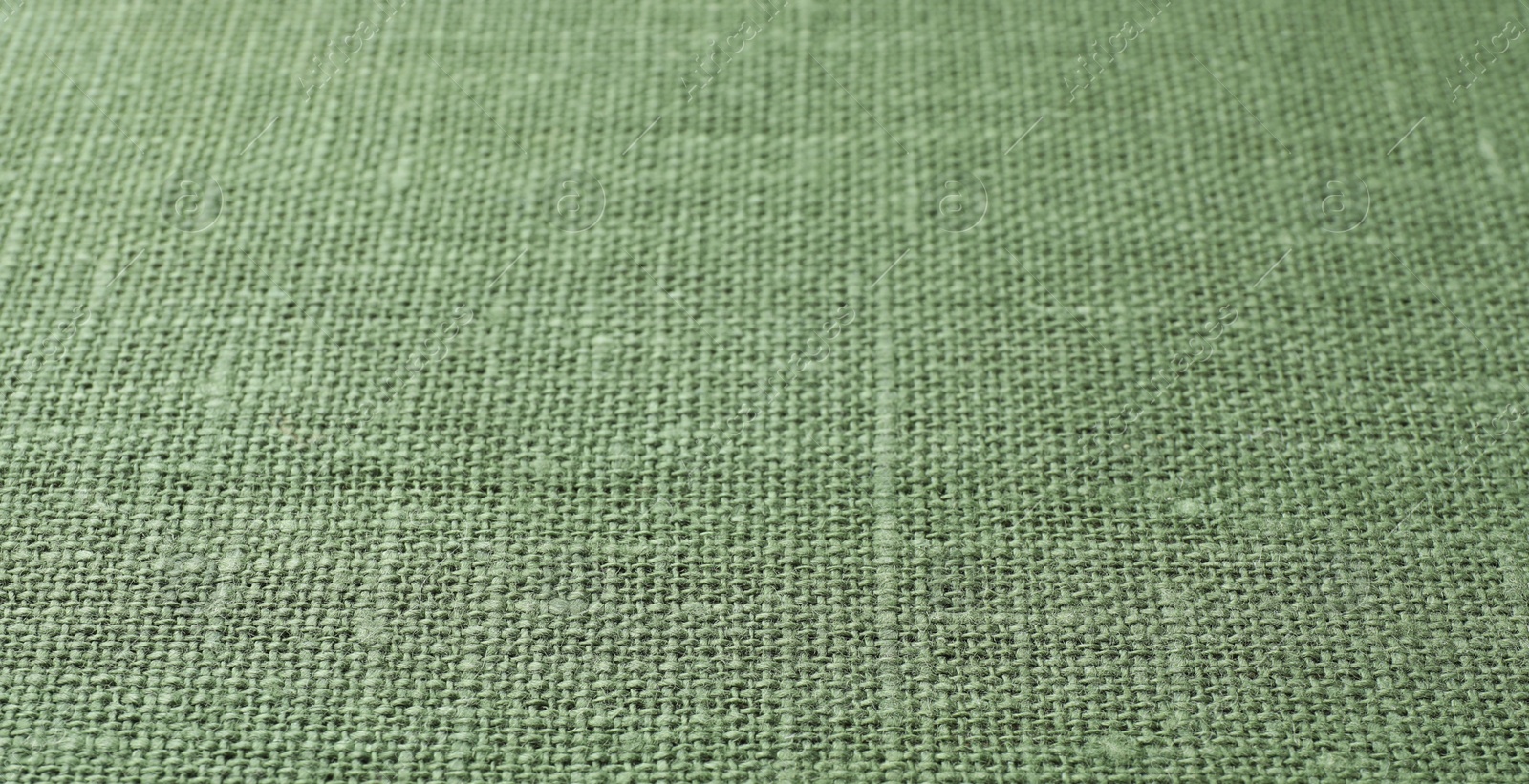 Photo of Texture of green fabric as background, closeup