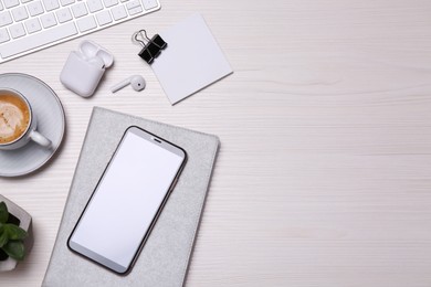 Photo of Flat lay composition with mobile phone on wooden table. Space for text