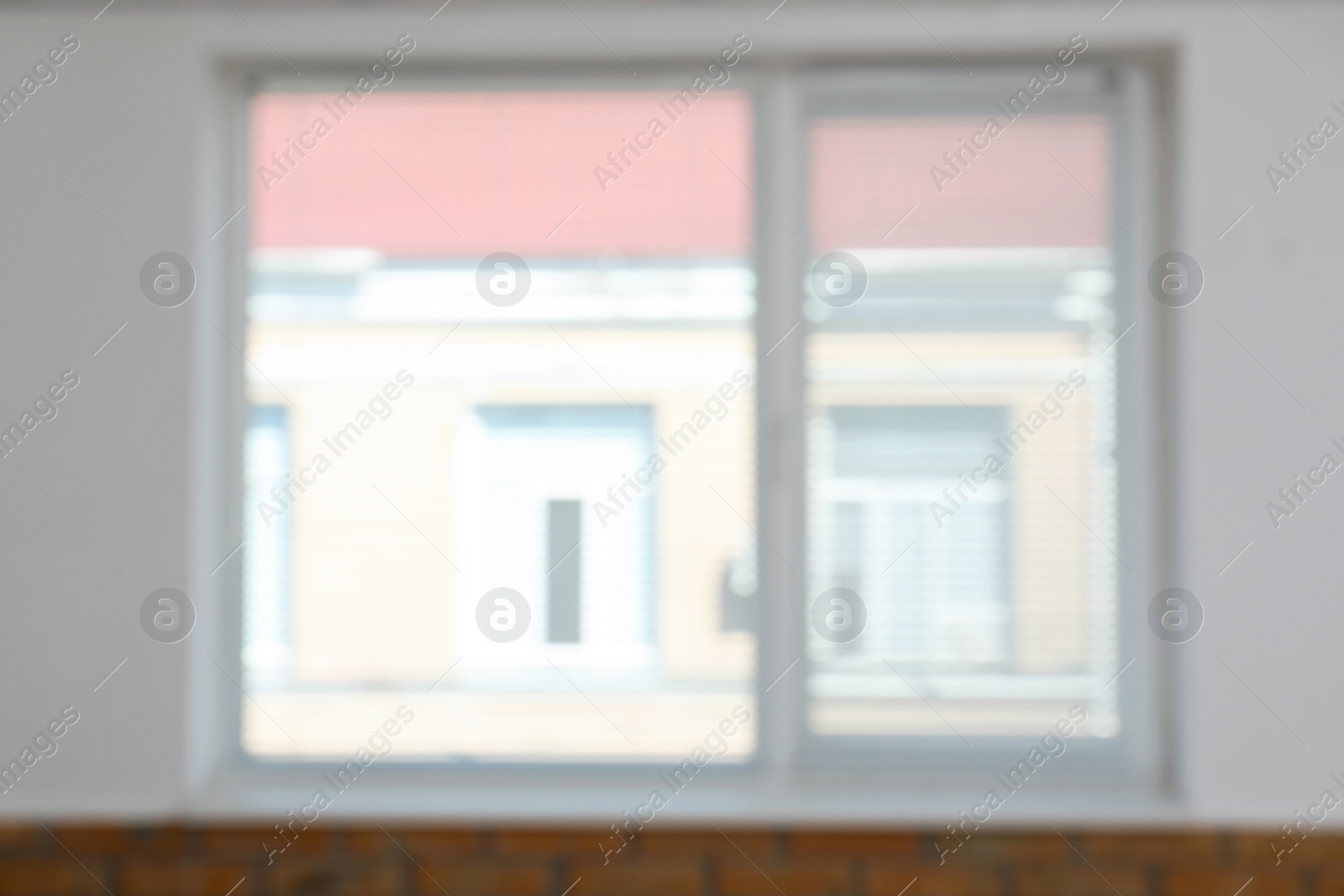 Photo of Blurred view of modern window with blinds in room