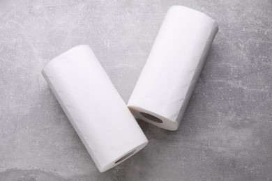 Photo of Rolls of tissue towels on light grey background, flat lay