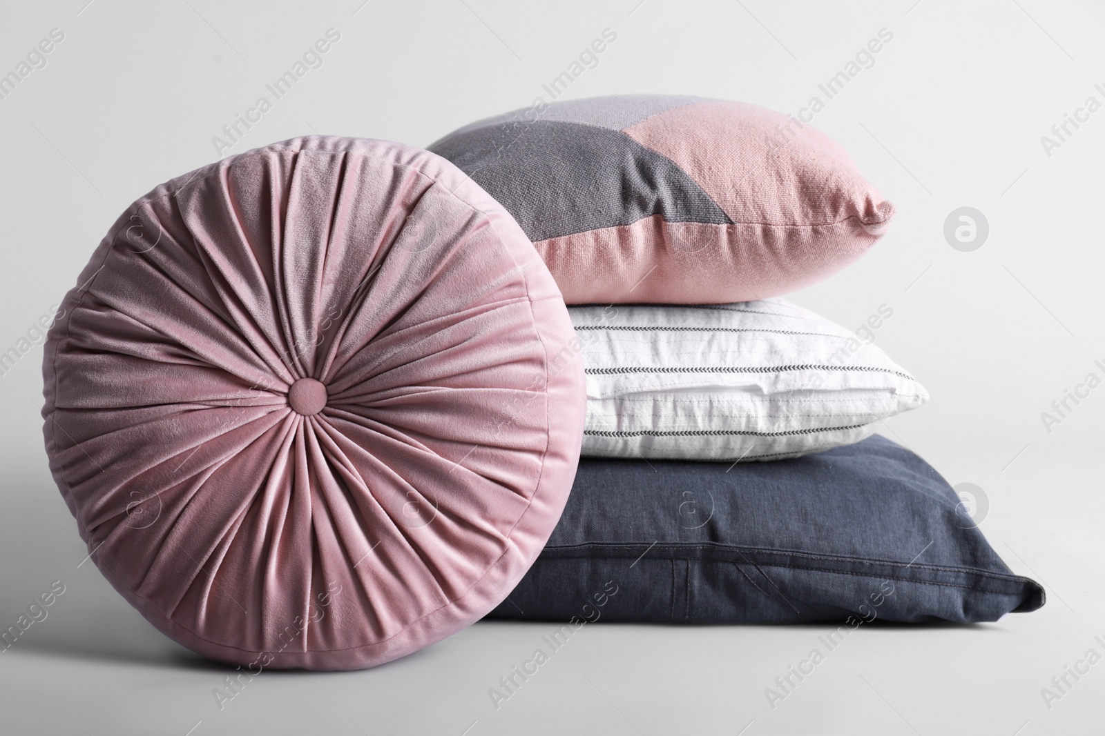 Photo of Different stylish soft pillows on grey background