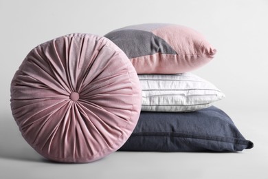 Photo of Different stylish soft pillows on grey background