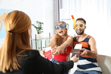 Photo of Beautiful young couple visiting travel agency office