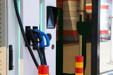 Modern electric vehicle charging station outdoors, closeup