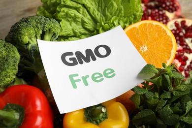 Photo of Tasty fresh GMO free products and paper card, closeup
