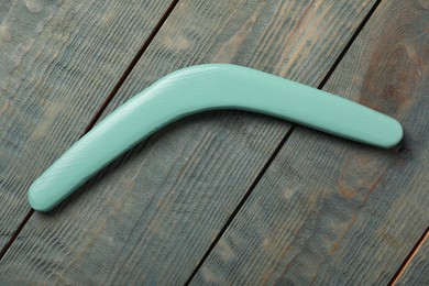 Boomerang on light blue wooden background, top view