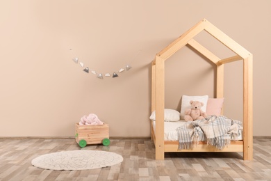 Stylish child room interior with house bed. Space for text