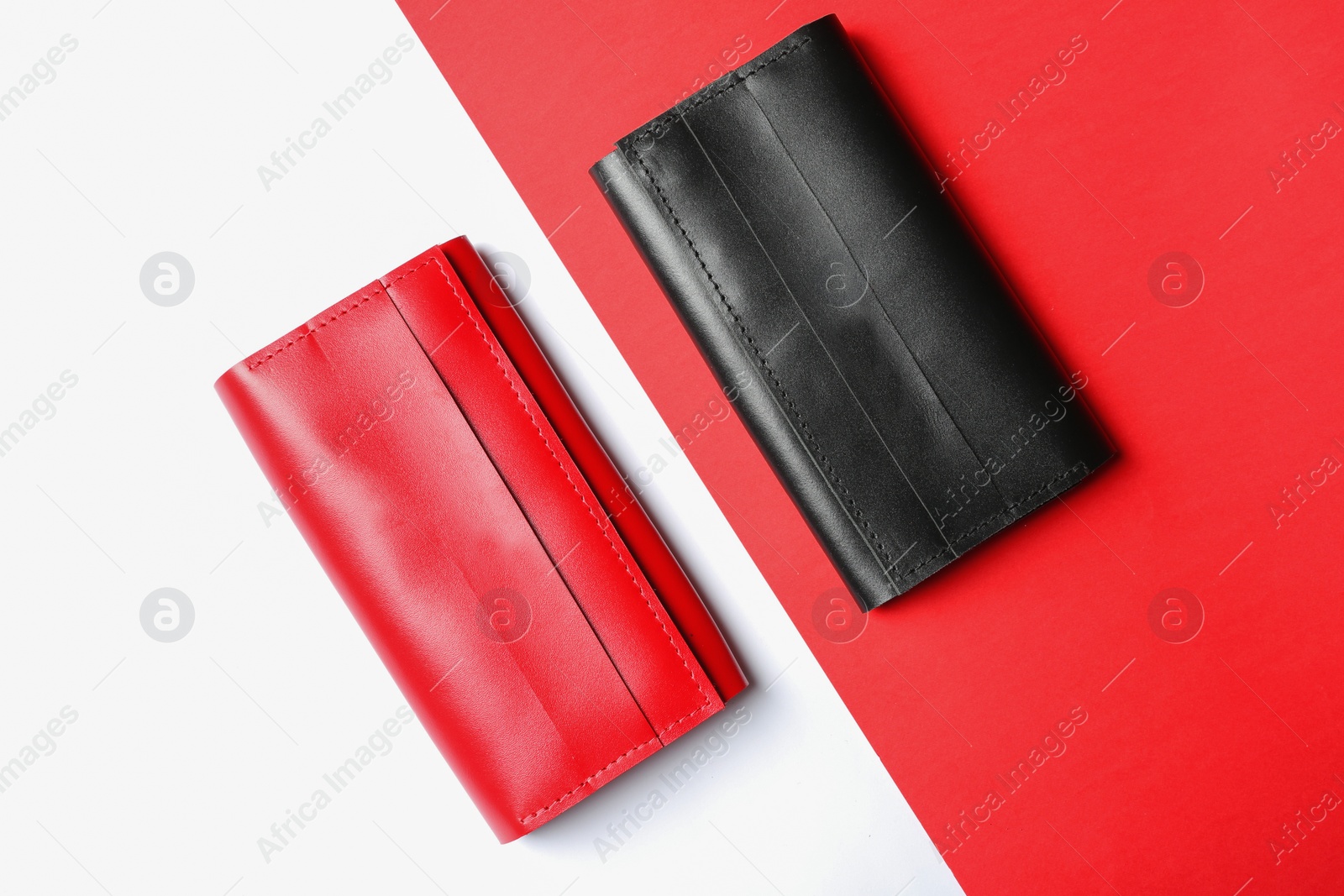 Photo of Stylish wallets on color background, top view