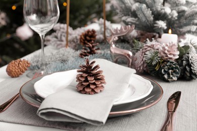 Luxury place setting with beautiful festive decor for Christmas dinner on table, closeup