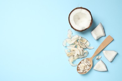 Photo of Flat lay composition with tasty coconut chips on light blue background. Space for text
