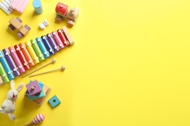 Photo of Flat lay composition with different toys on yellow background. Space for text