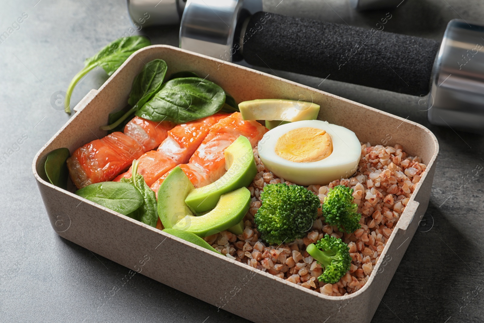 Photo of Container with natural healthy lunch on table. High protein food